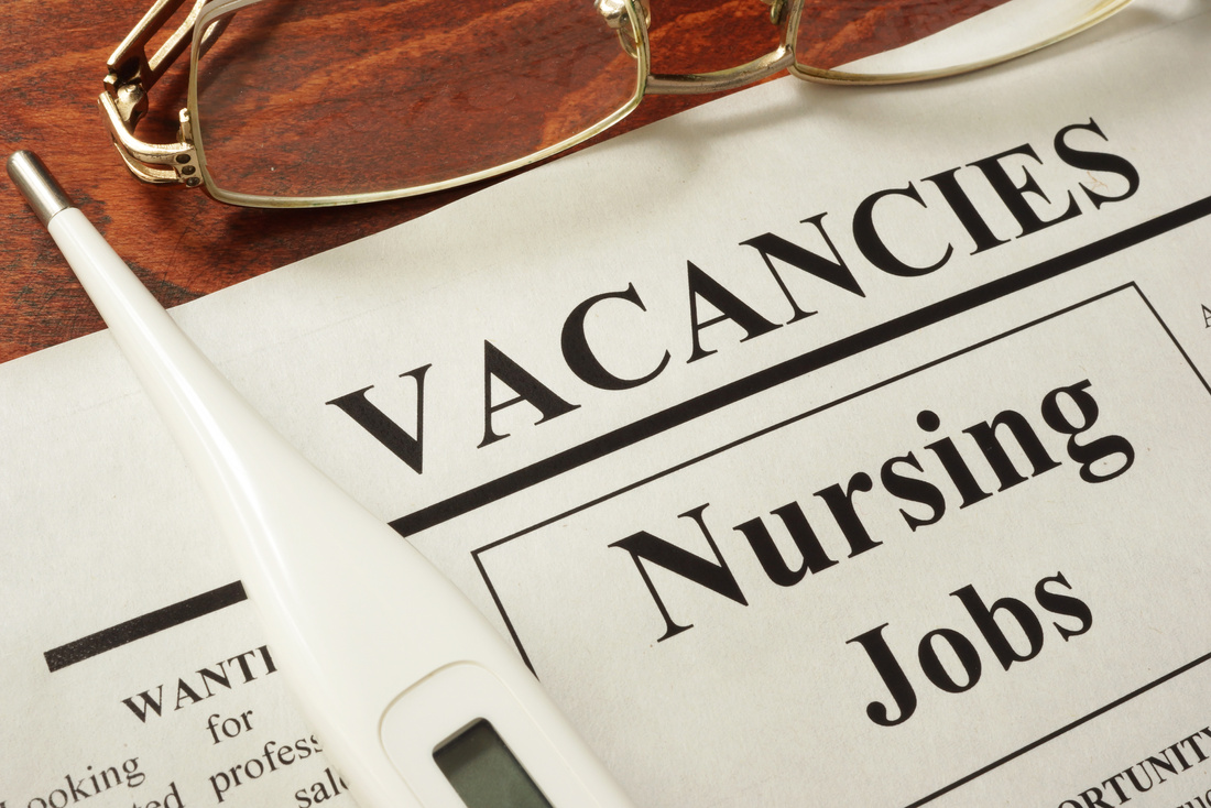 Newspaper with ads nursing jobs vacancy. Occupation concept.